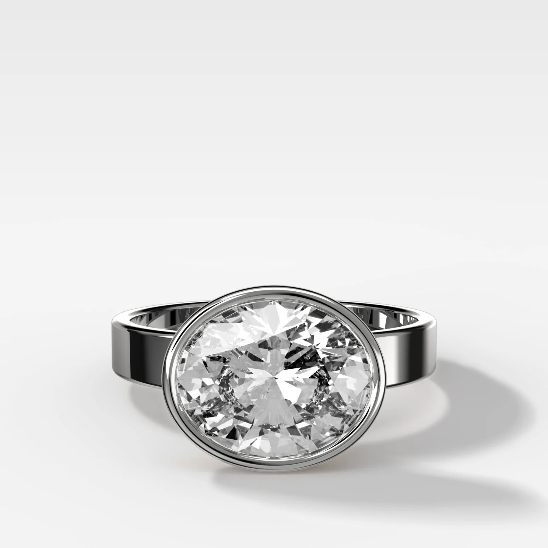 Finest Bezel Set Engagement Ring With East West Oval Cut Diamond - Image 3